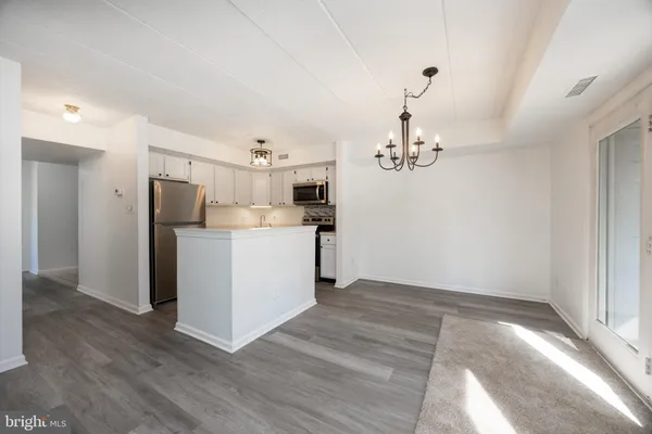 a view of a kitchen with refrigerator and microwave