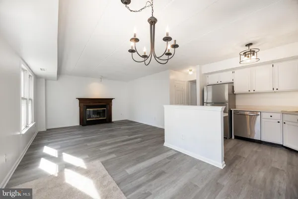 a view of kitchen and hall with wooden floor