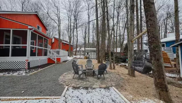 a view of a house with backyard porch and sitting area