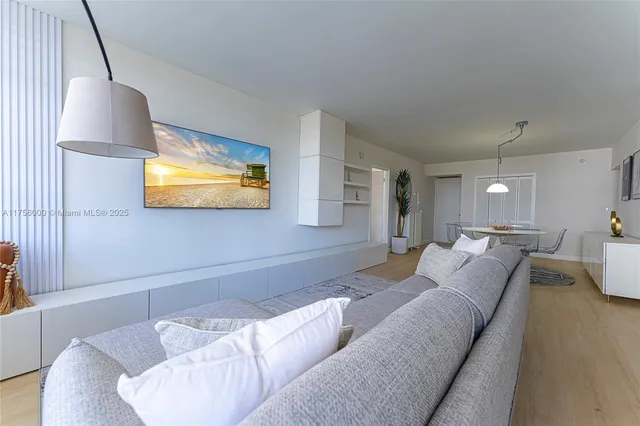 a living room with furniture and a lamp