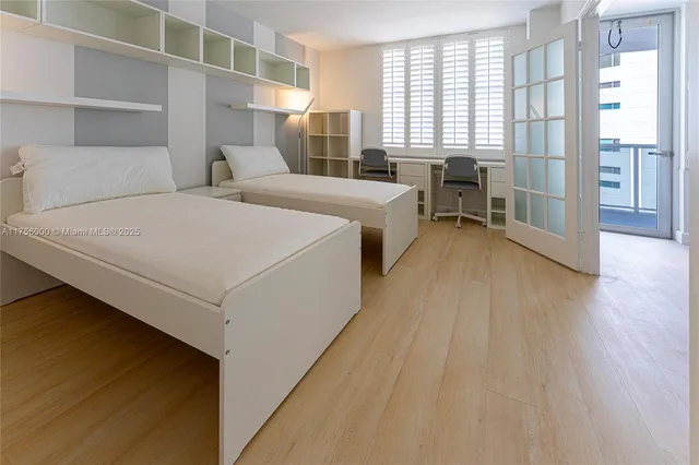 a room with a bed and a large window