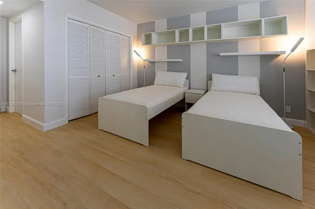 a utility room with closet and windows