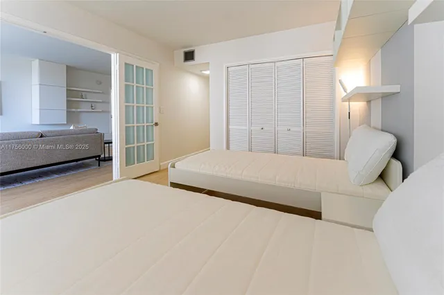 a bedroom with a large bed and a window