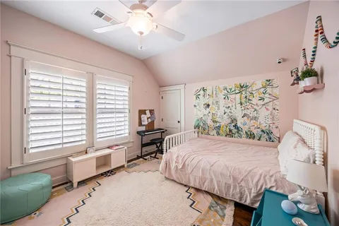 a bedroom with a bed dresser and a window