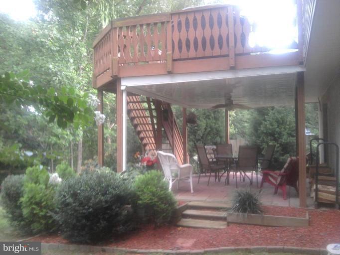 8030 Pine Ridge Road Pasadena, MD 21122 - Photo 2 of 8 a view of a house with backyard and sitting area