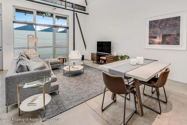 a view of a livingroom with furniture and a flat screen tv