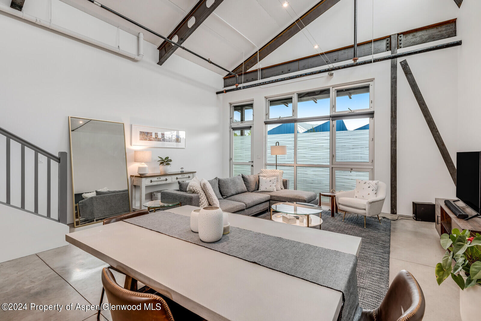 28 Widget Street, Unit 415 Basalt, CO 81621 - Photo 4 of 23 a view of a dining room with furniture a chandelier and wooden floor