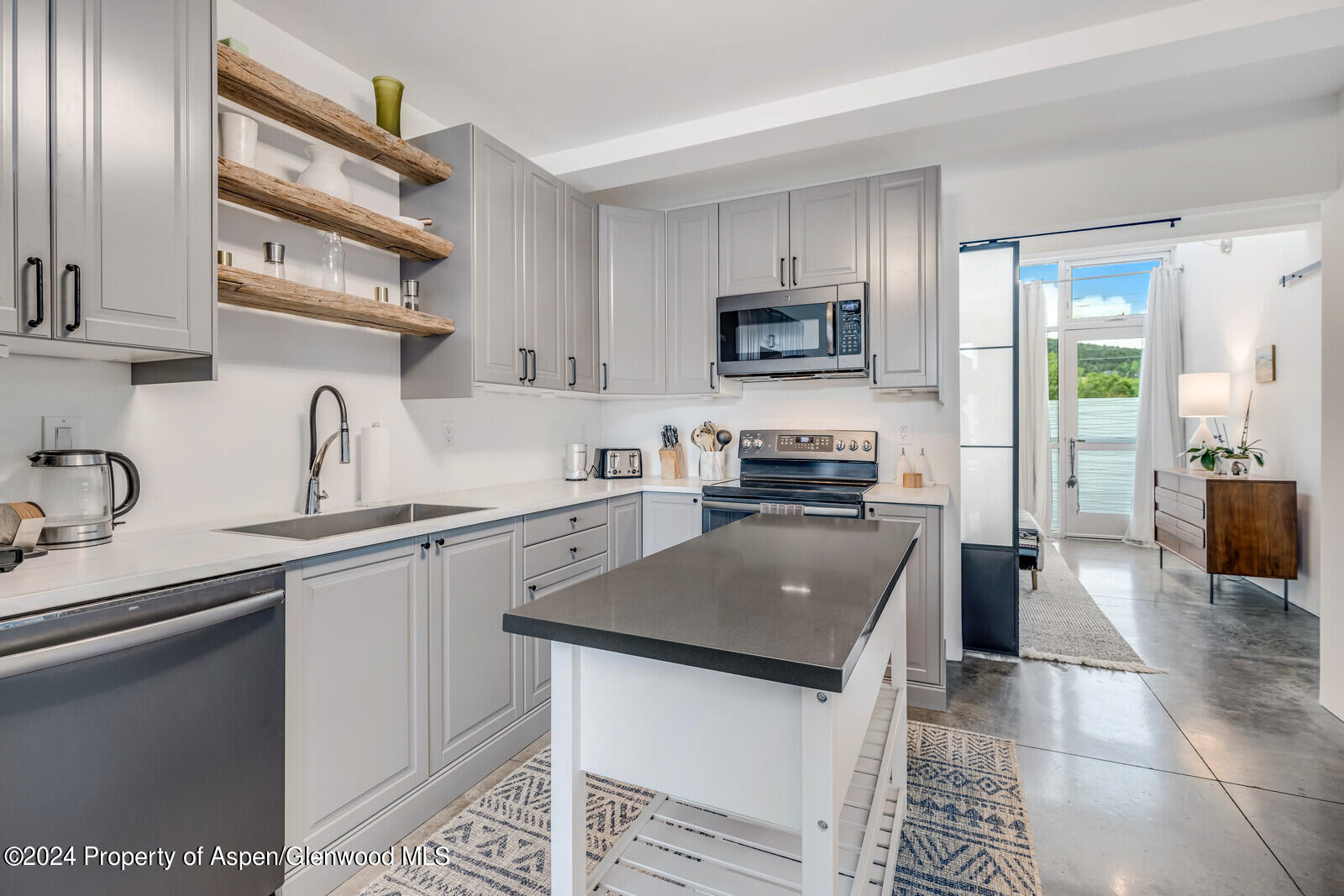 28 Widget Street, Unit 415 Basalt, CO 81621 - Photo 6 of 23 a kitchen with a sink a counter top space cabinets and stainless steel appliances