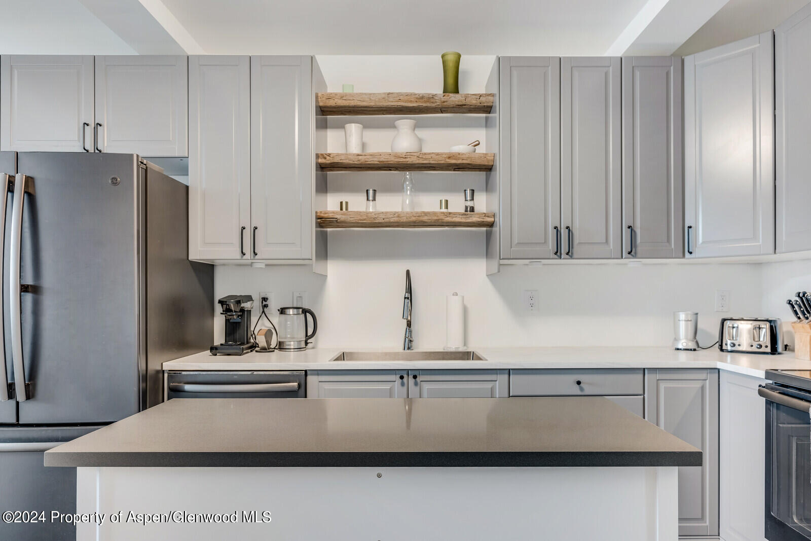 28 Widget Street, Unit 415 Basalt, CO 81621 - Photo 8 of 23 a kitchen with a sink a refrigerator and cabinets