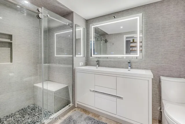 a bathroom with a sink toilet and shower