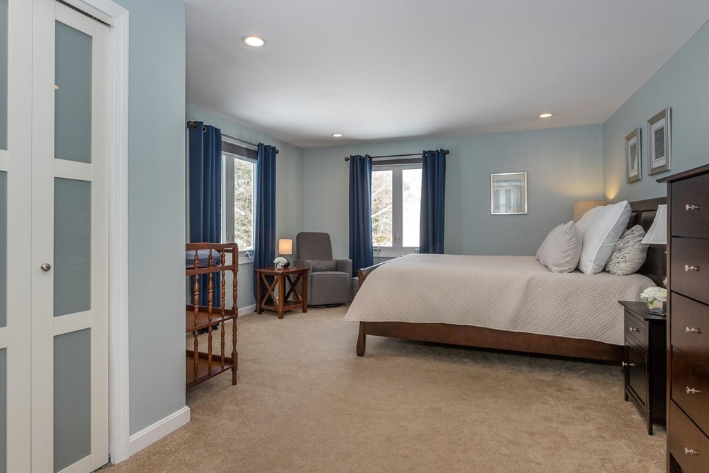 38 Clover Lane Stoughton, MA 02072 - Photo 11 of 21 a bedroom with a bed a table and a large mirror