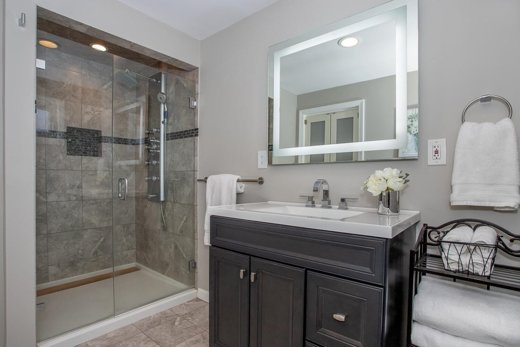 38 Clover Lane Stoughton, MA 02072 - Photo 12 of 21 a bathroom with a sink a mirror and a shower