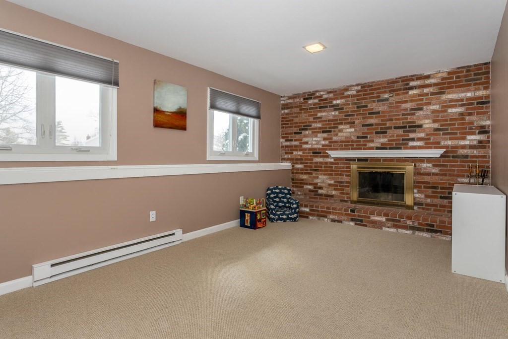 38 Clover Lane Stoughton, MA 02072 - Photo 16 of 21 a view of room with two windows and a fireplace