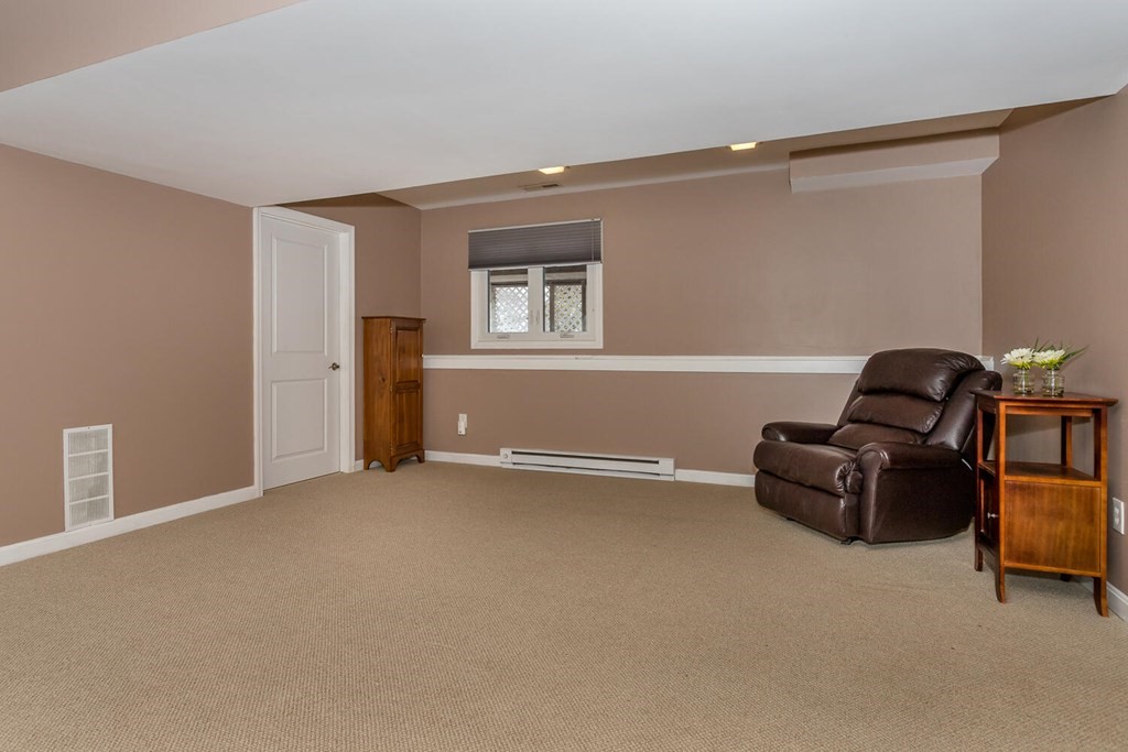 38 Clover Lane Stoughton, MA 02072 - Photo 18 of 21 a living room with furniture and a window