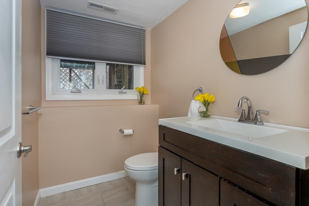 38 Clover Lane Stoughton, MA 02072 - Photo 19 of 21 a bathroom with a toilet sink and mirror