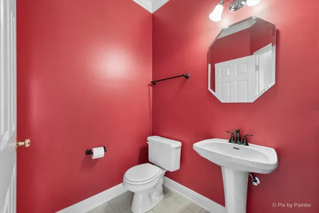 a bathroom with a sink a toilet and mirror