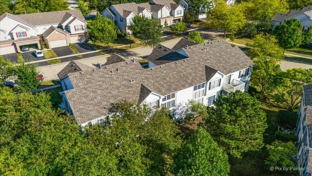 an aerial view of a house with large trees