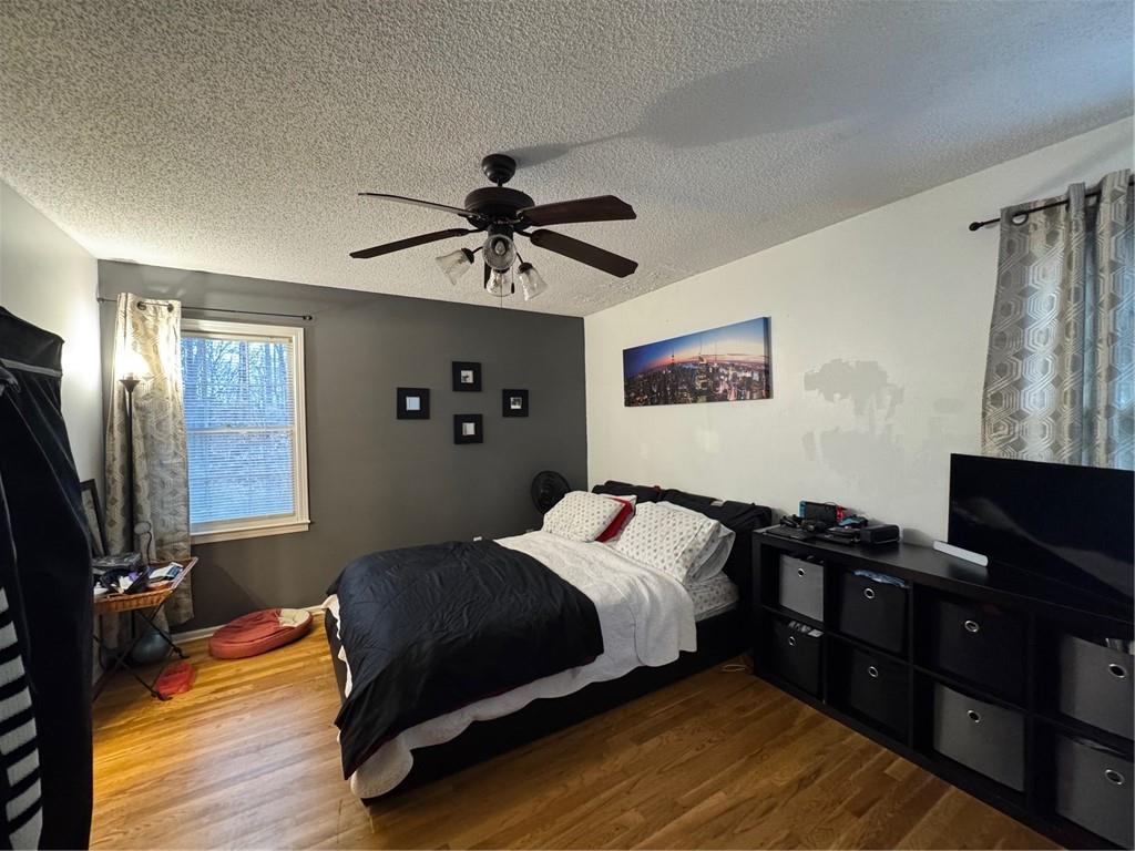 1019 Davis Mill Road South Dallas, GA 30157 - Photo 11 of 16 a bedroom with a bed and wooden floor