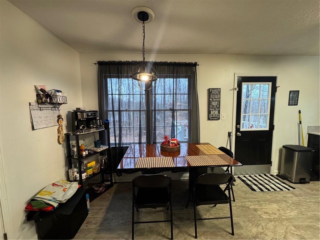 1019 Davis Mill Road South Dallas, GA 30157 - Photo 7 of 16 a living room with furniture a chandelier and a window