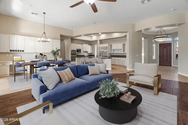 a living room with furniture a table and a large window