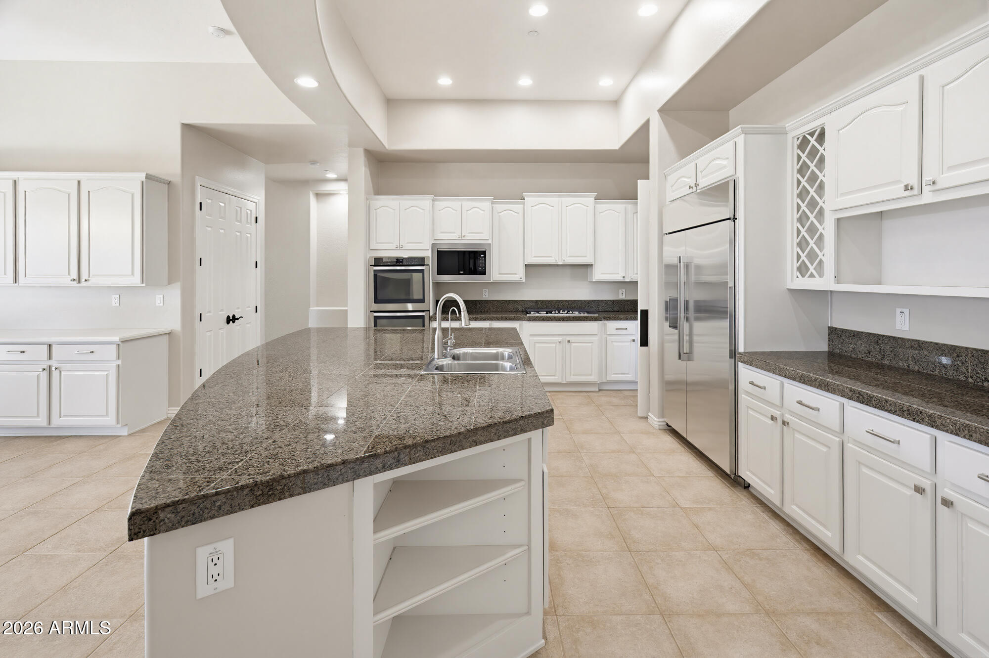 42420 North Back Creek Way Anthem, AZ 85086 - Photo 17 of 70 a large kitchen with kitchen island granite countertop a sink a stove counter space and cabinets