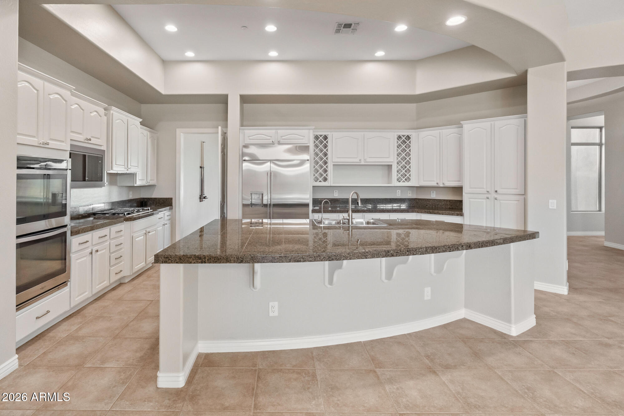 42420 North Back Creek Way Anthem, AZ 85086 - Photo 19 of 70 a large kitchen with stainless steel appliances granite countertop a stove and a sink
