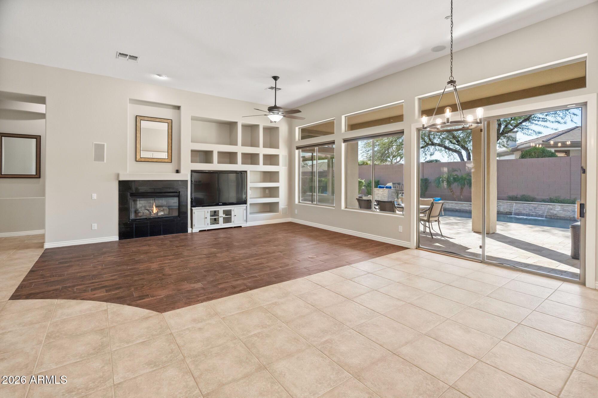 42420 North Back Creek Way Anthem, AZ 85086 - Photo 24 of 70 a view of an empty room with a fireplace and a window