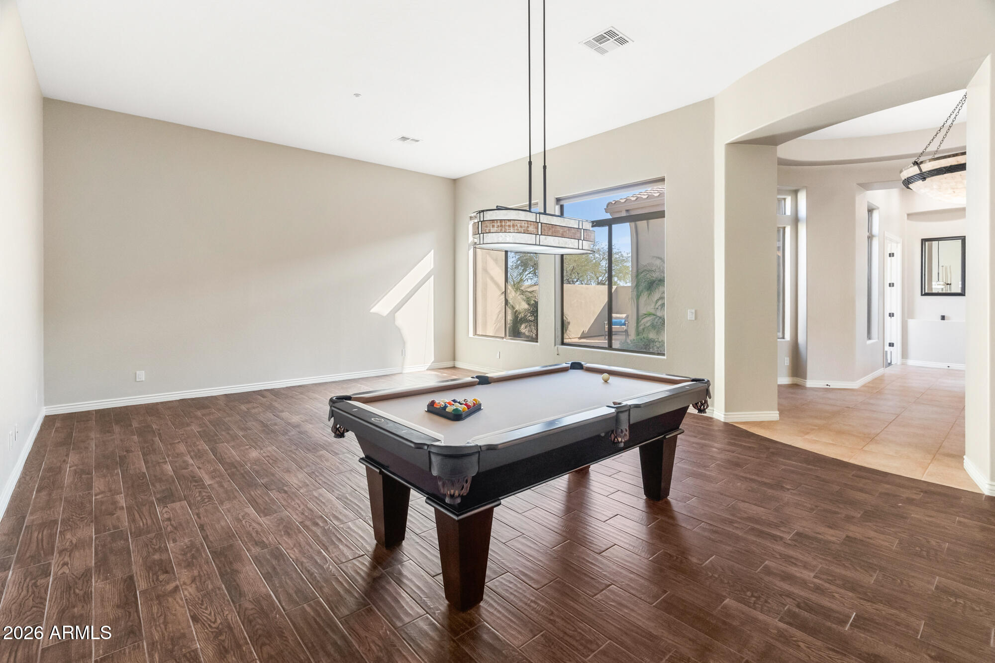 42420 North Back Creek Way Anthem, AZ 85086 - Photo 29 of 70 a view of a room with wooden floor table and chairs
