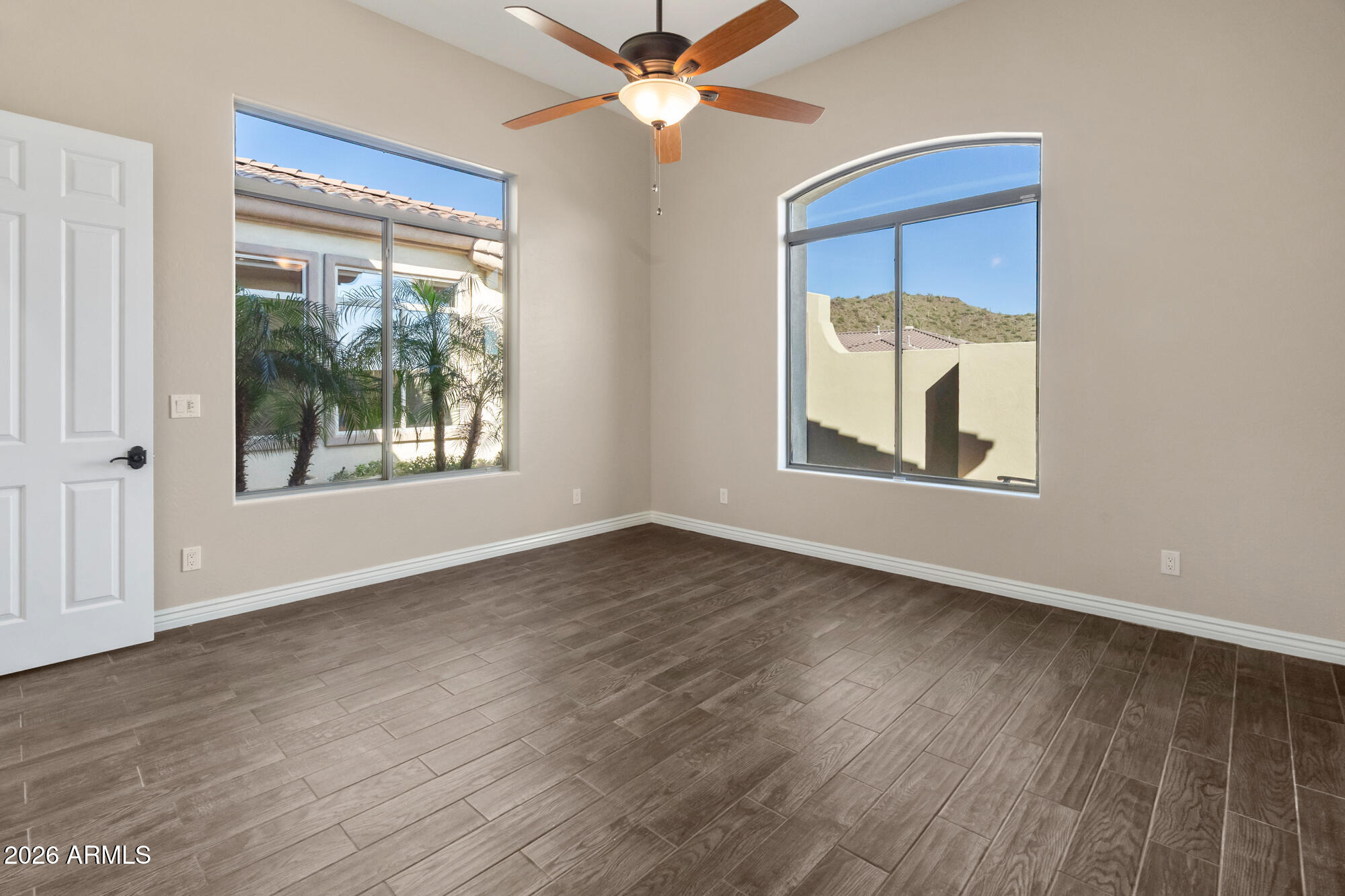 42420 North Back Creek Way Anthem, AZ 85086 - Photo 41 of 70 a view of an empty room with a window and wooden floor