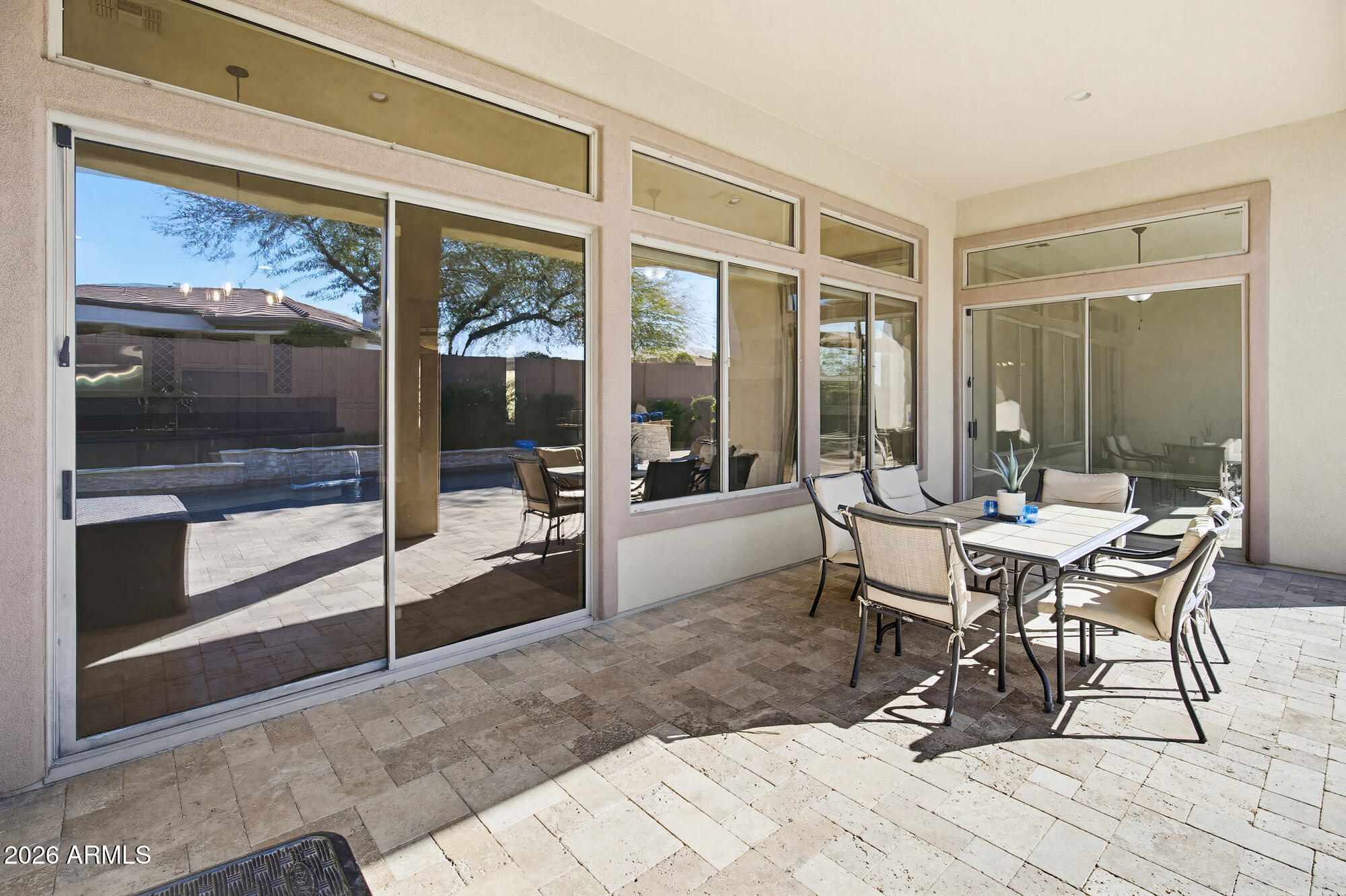 42420 North Back Creek Way Anthem, AZ 85086 - Photo 56 of 70 a dining room with a glass top table and chairs