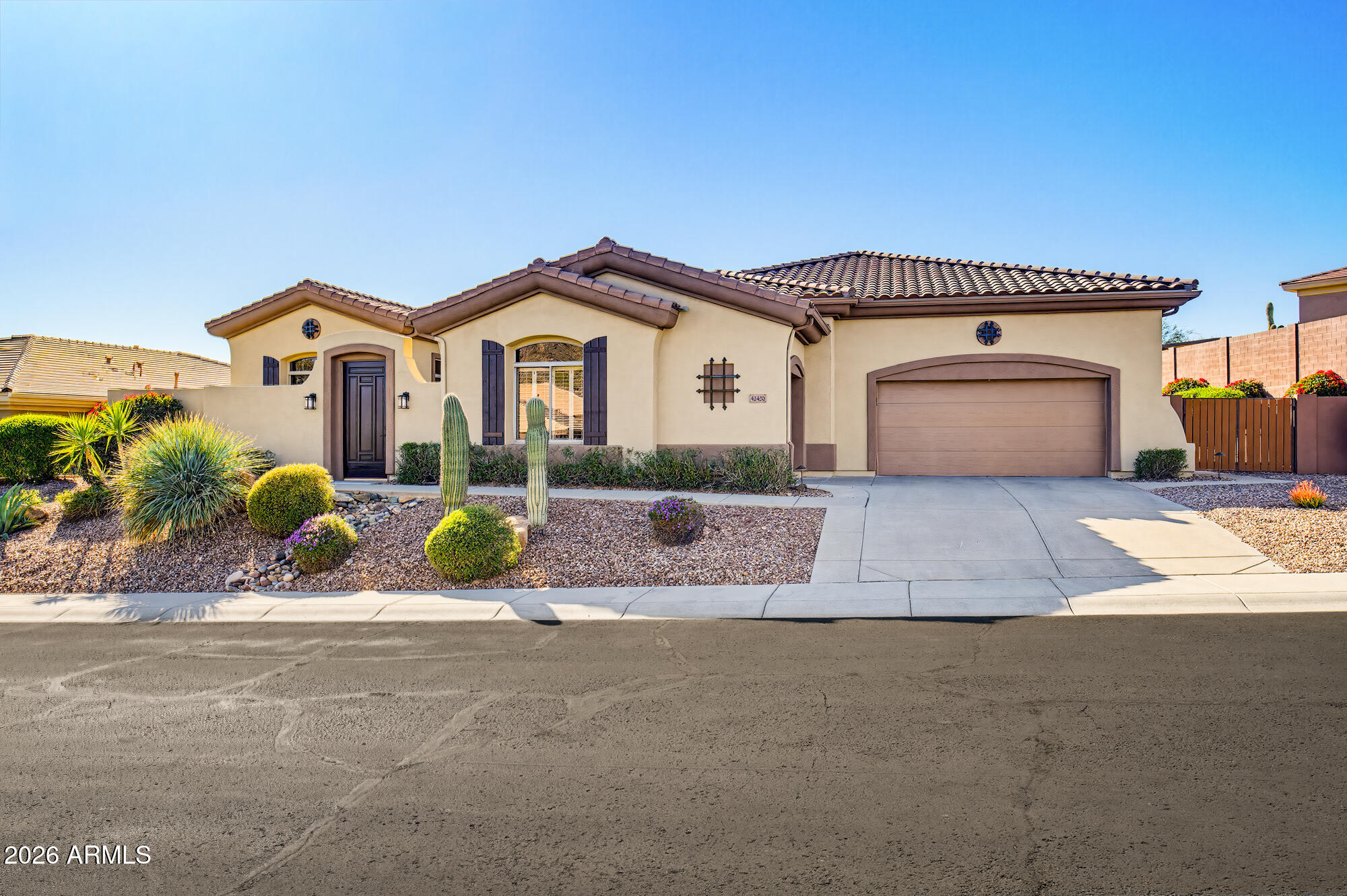 42420 North Back Creek Way Anthem, AZ 85086 - Photo 7 of 70 a front view of a house with a yard and potted plants