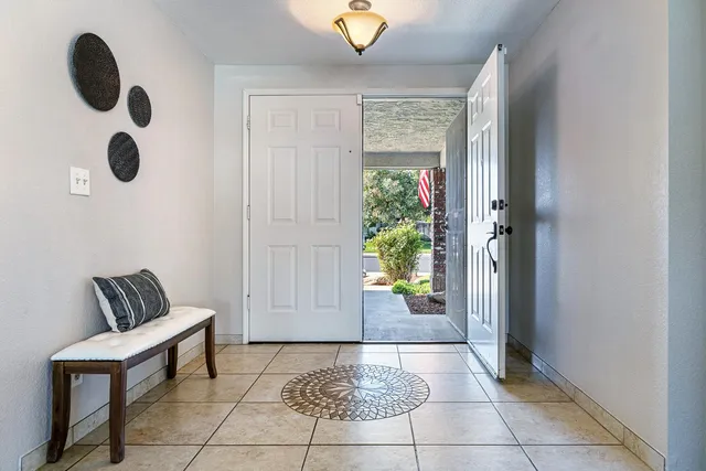 a living room with furniture a chandelier and a window