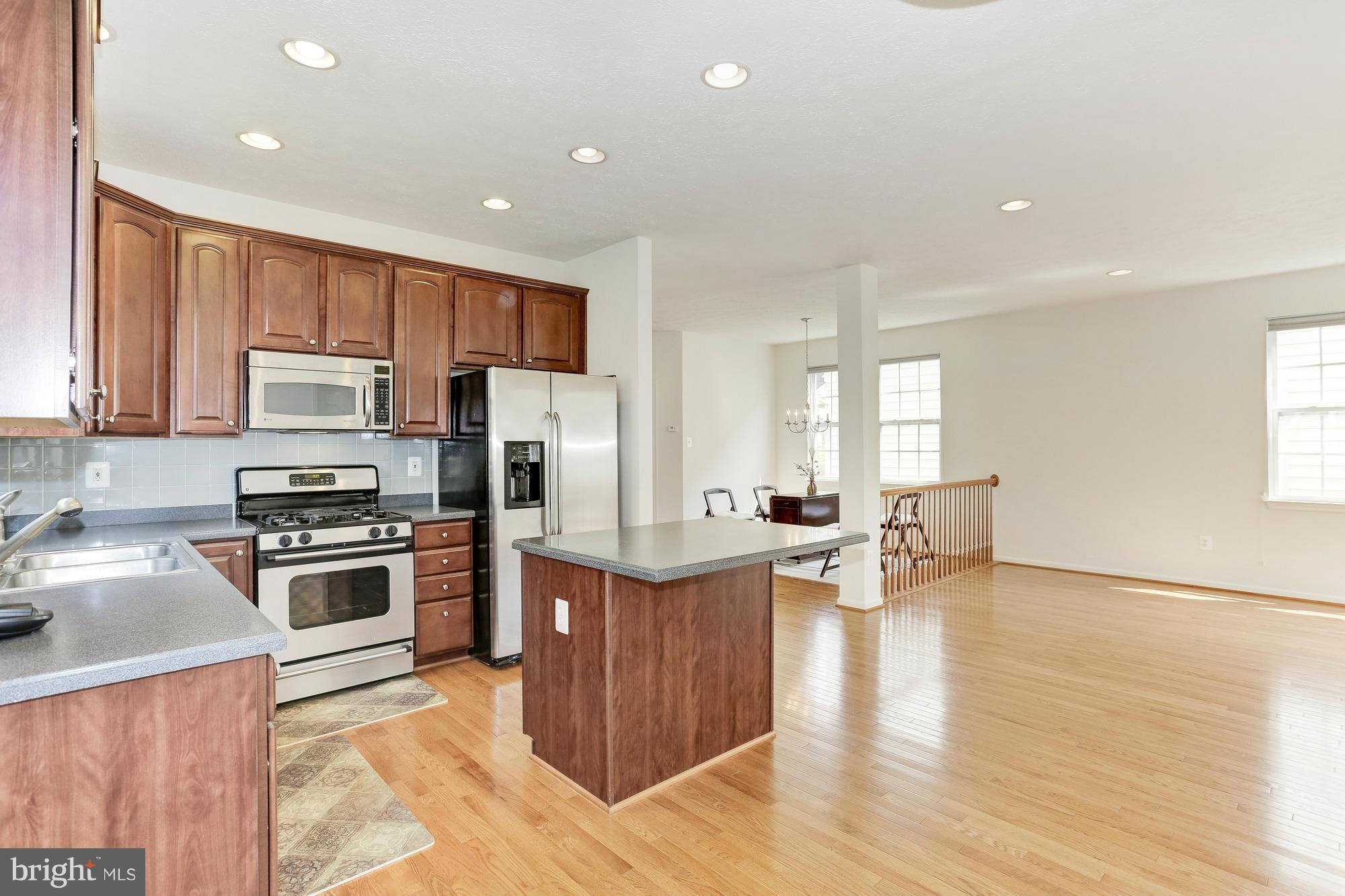 9637 Biggs Road Middle River, MD 21220 - Photo 14 of 30 a kitchen with kitchen island a stove a sink a refrigerator and cabinets
