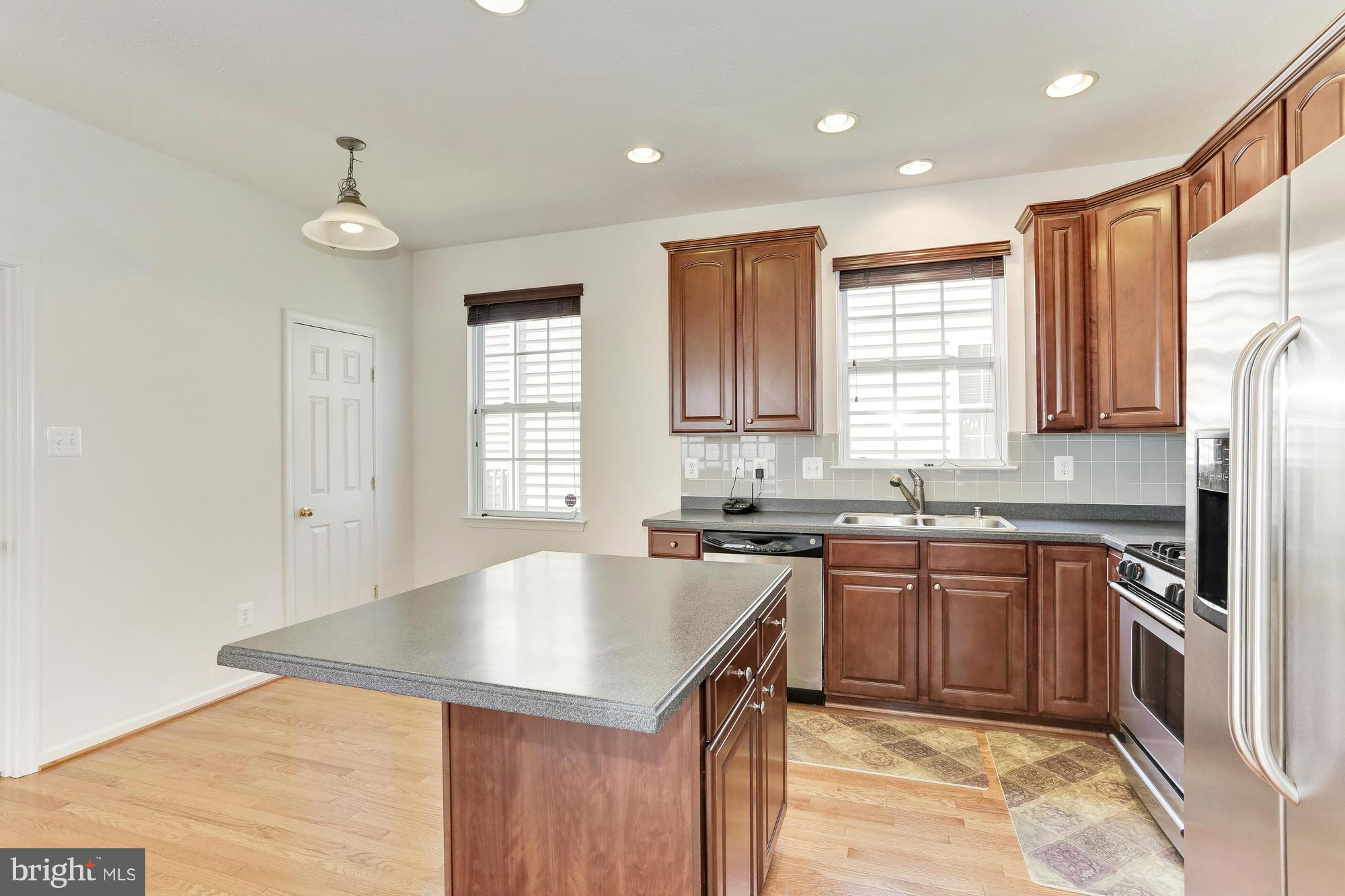 9637 Biggs Road Middle River, MD 21220 - Photo 17 of 30 a kitchen with granite countertop a sink stainless steel appliances cabinets and a window
