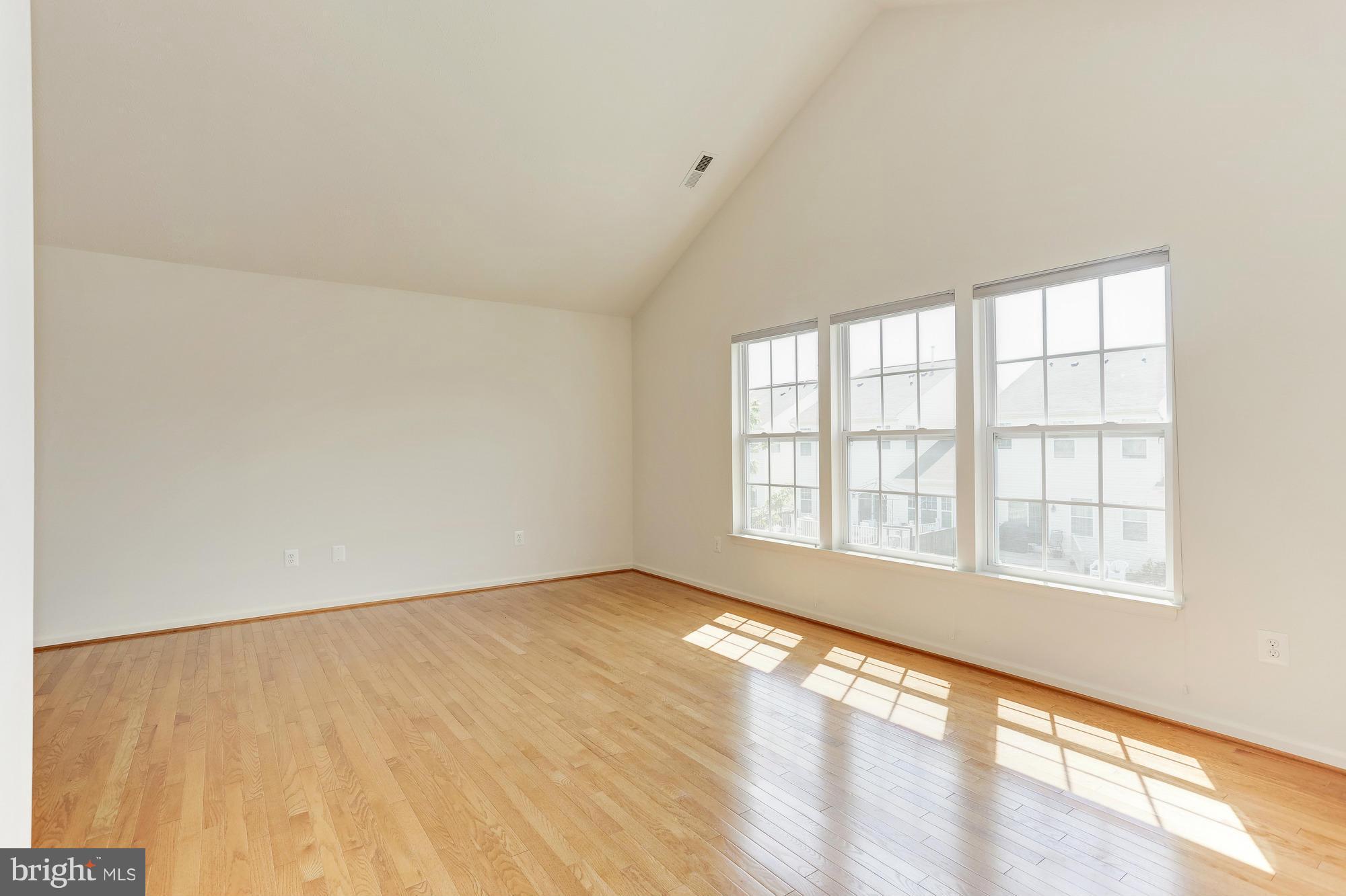 9637 Biggs Road Middle River, MD 21220 - Photo 21 of 30 an empty room with wooden floor and windows