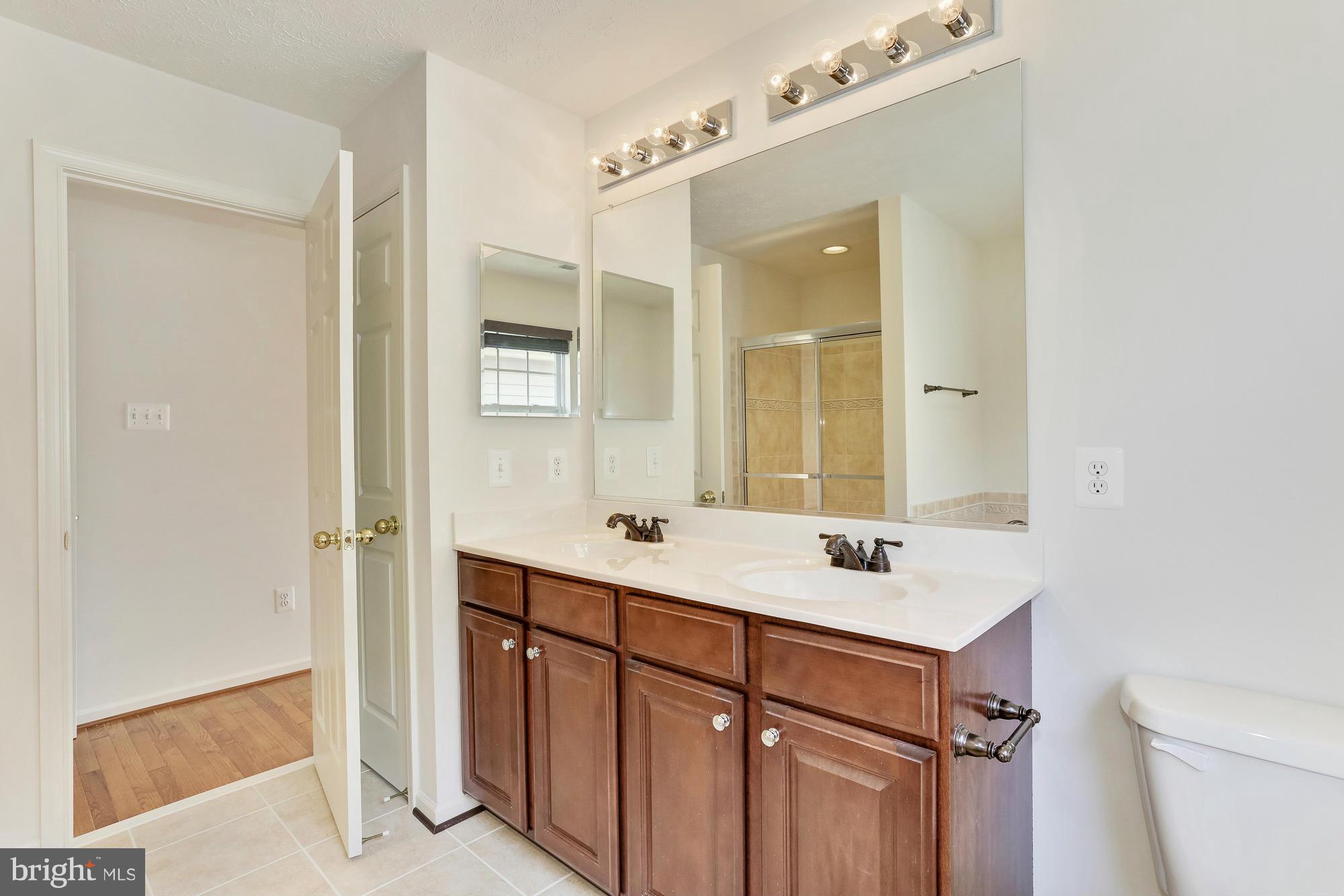 9637 Biggs Road Middle River, MD 21220 - Photo 23 of 30 a bathroom with a sink a mirror and a toilet