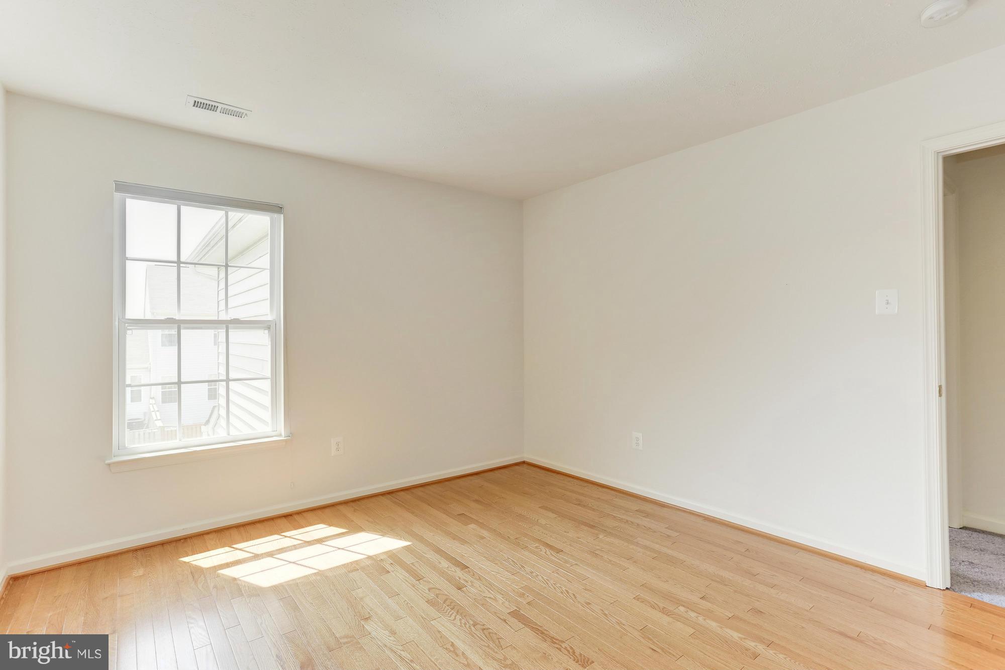 9637 Biggs Road Middle River, MD 21220 - Photo 25 of 30 an empty room with wooden floor and windows