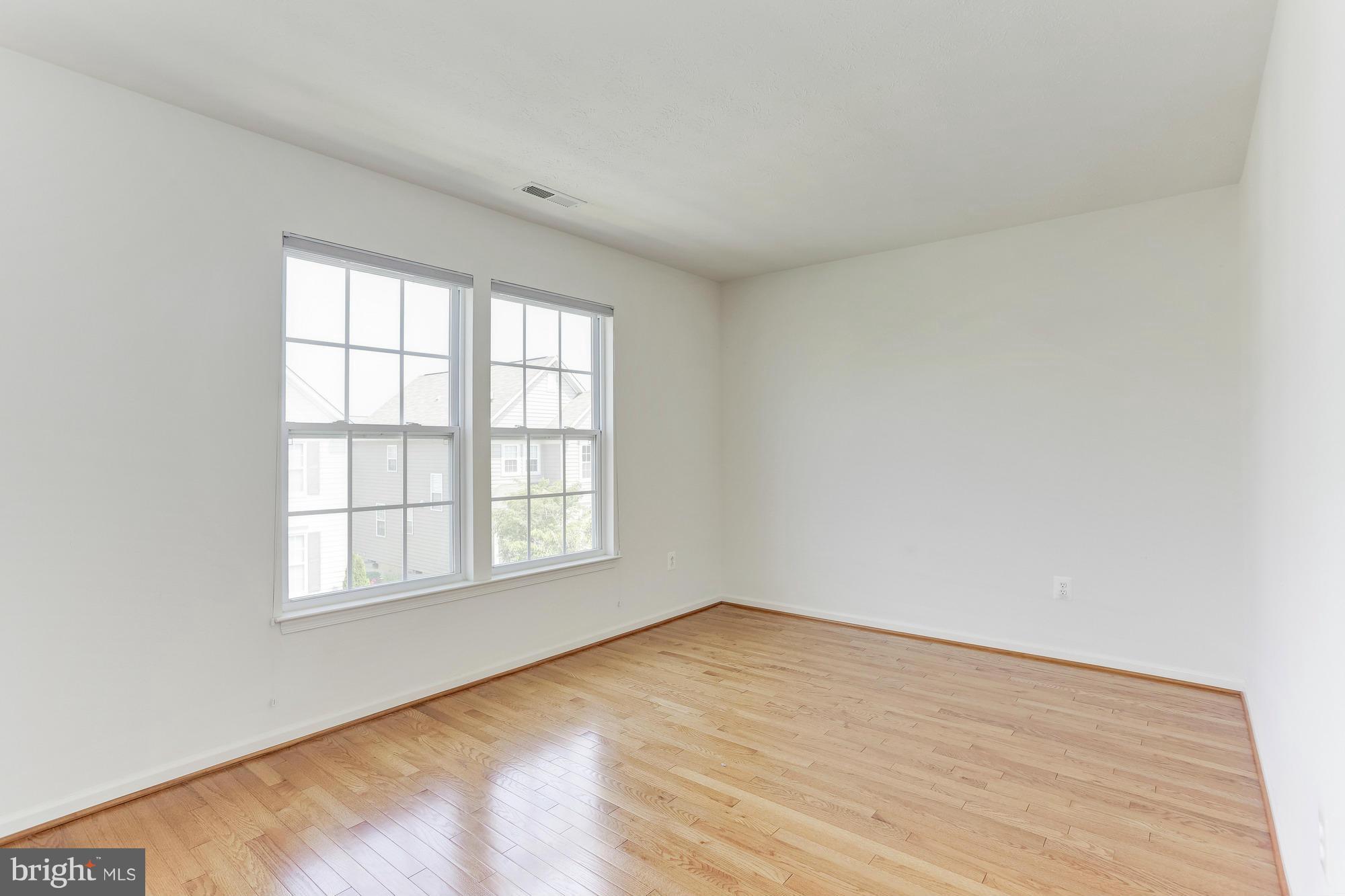 9637 Biggs Road Middle River, MD 21220 - Photo 27 of 30 an empty room with wooden floor and windows