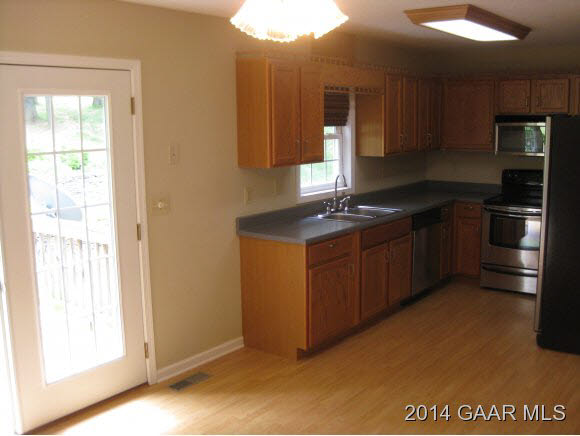 523 Stover Shop Road Churchville, VA 24421 - Photo 8 of 25 a kitchen with stainless steel appliances granite countertop a sink stove and refrigerator
