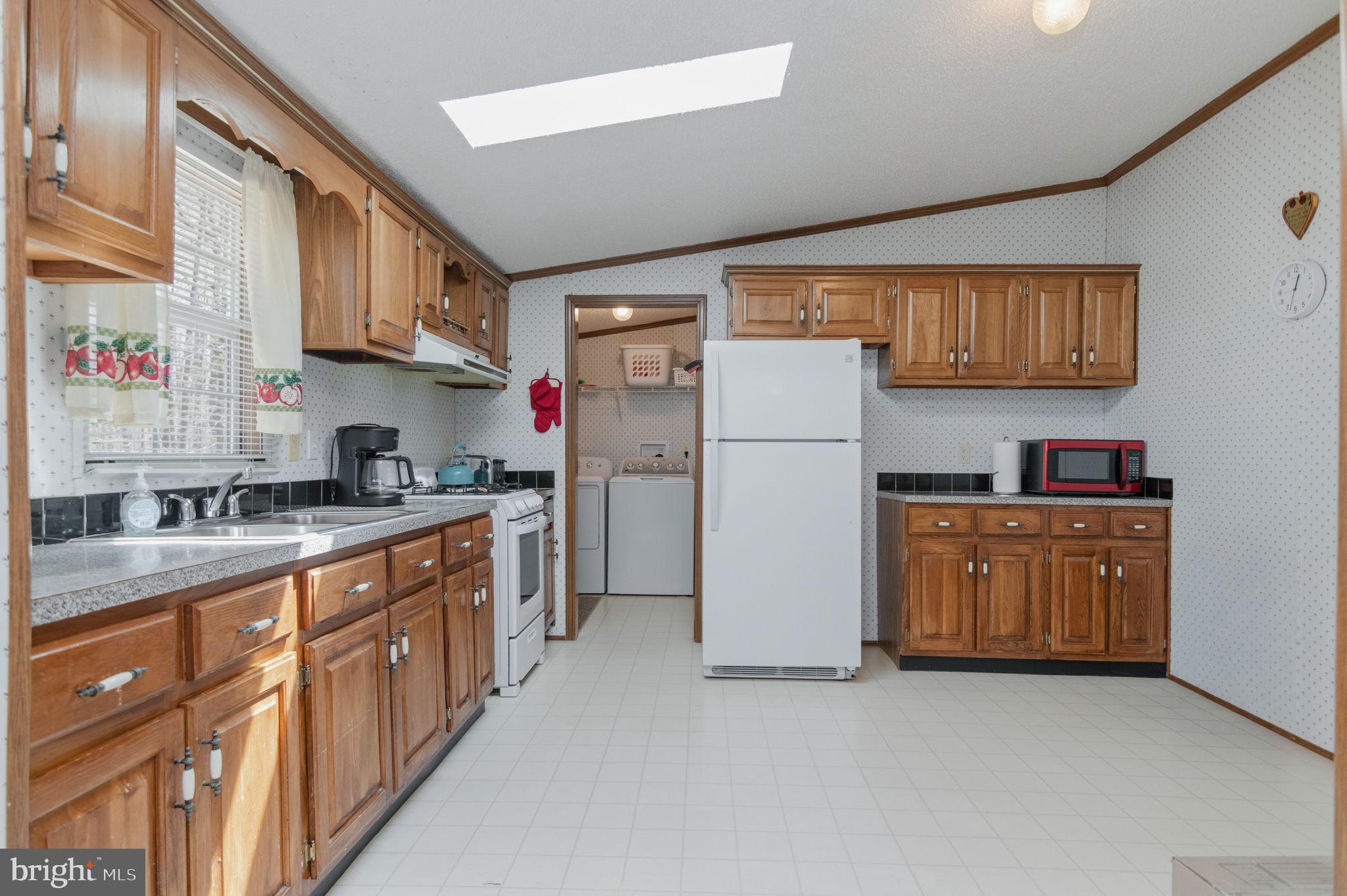 19341 Lahore Road Orange, VA 22960 - Photo 16 of 39 a kitchen with refrigerator a stove a sink and cabinets