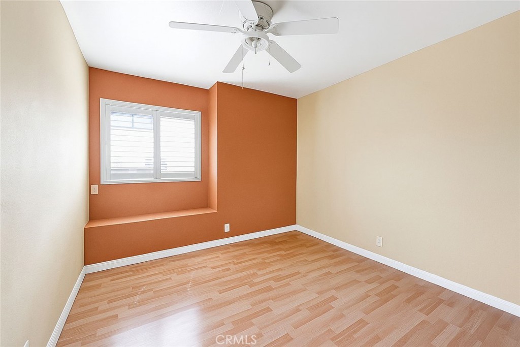 970 West Norwood Street Rialto, CA 92377 - Photo 15 of 17 an empty room with a chandelier fan and windows
