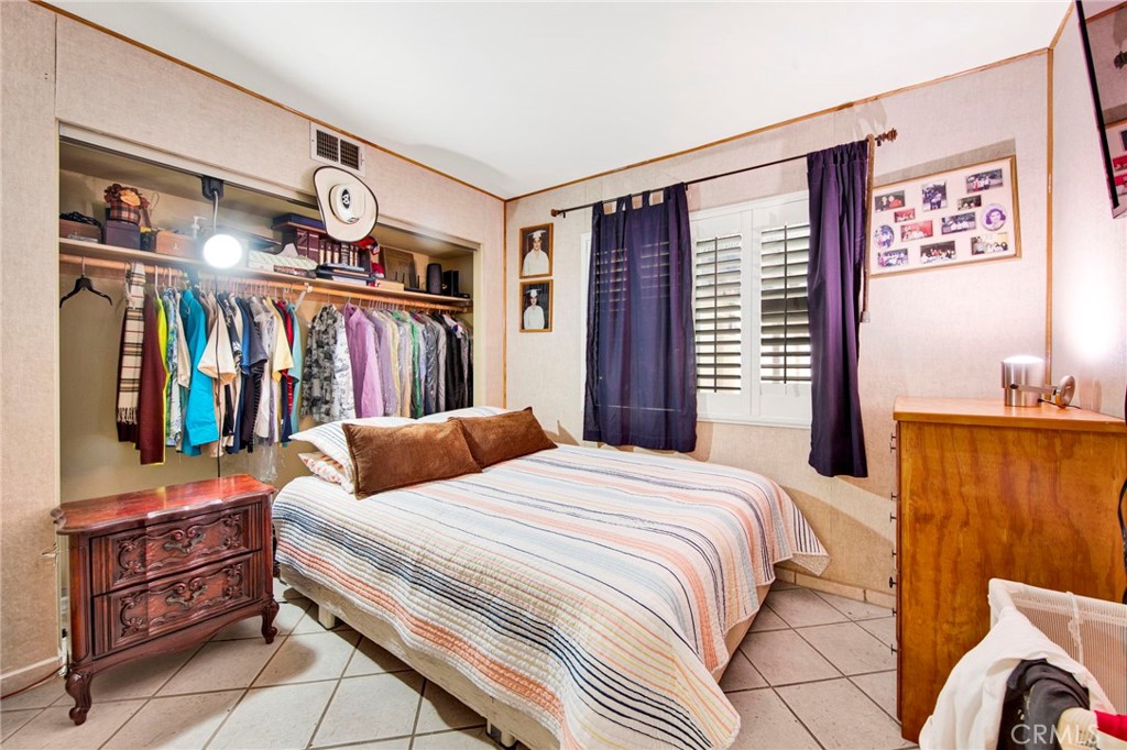 970 West Norwood Street Rialto, CA 92377 - Photo 7 of 17 a bedroom with a large bed and a window