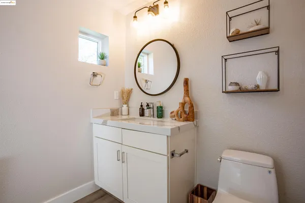 a bathroom with a toilet sink and mirror
