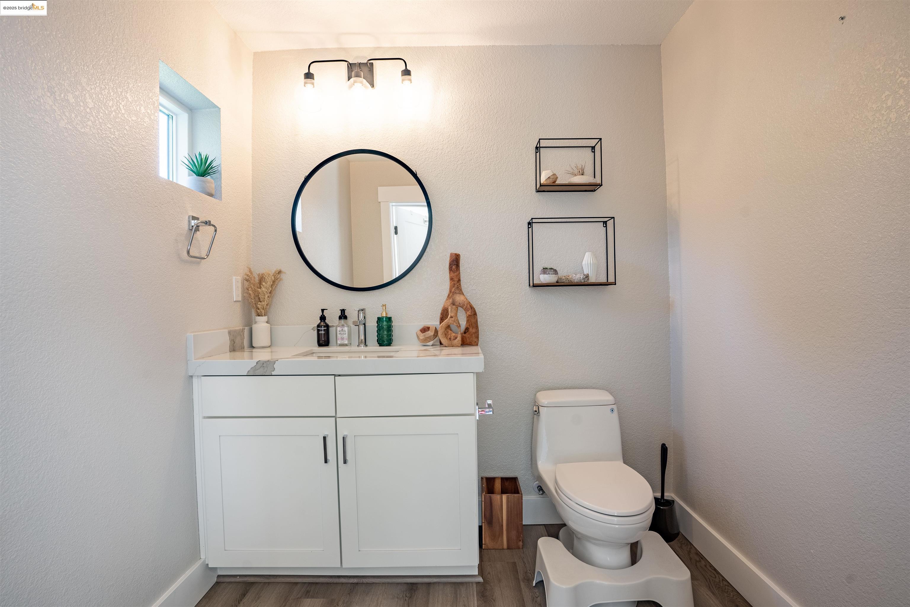 2640 Jones Road, Unit A Walnut Creek, CA 94597 - Photo 12 of 43 a bathroom with a toilet a sink and a mirror