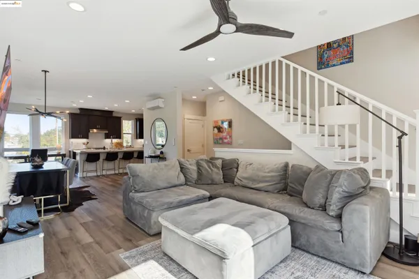 a living room with furniture and a chandelier