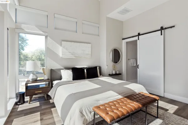 a bedroom with a bed lamp closet and window