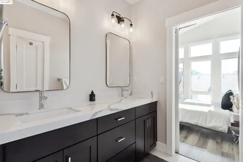 a bathroom with a double vanity sink and a mirror