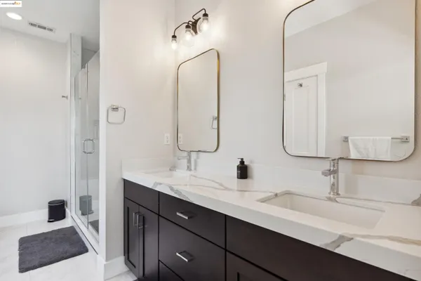 a bathroom with a double vanity sink and mirror