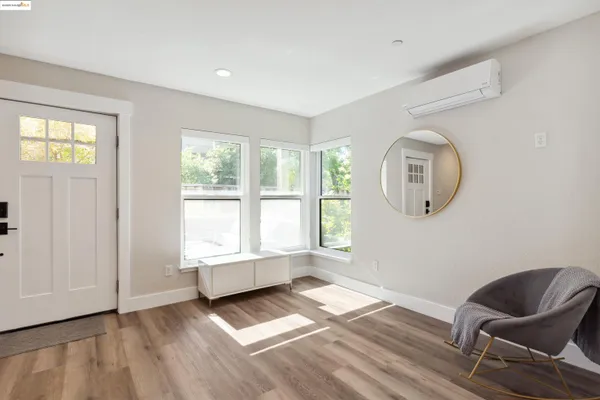 a view of a room with wooden floor and windows