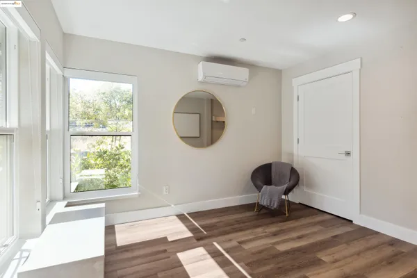 a view of a livingroom with wooden floor and a window